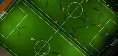 Aerial top view of a mini football match, soccer. MiniFootball field and Footballers from drone